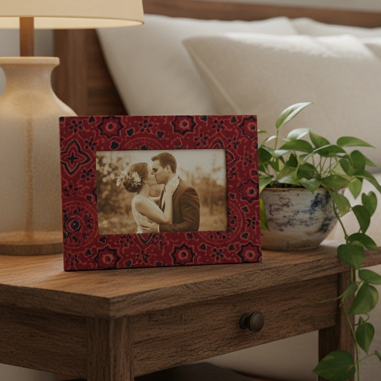 Handcrafted red block-printed photo frame holding a 3×5 photograph, artisanal fabric design