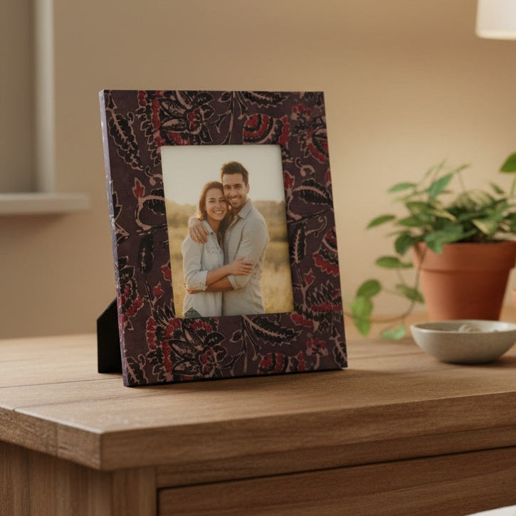Handmade brown and red floral block-printed photo frame holding a 3×5 photograph, artisanal fabric frame for home décor.
