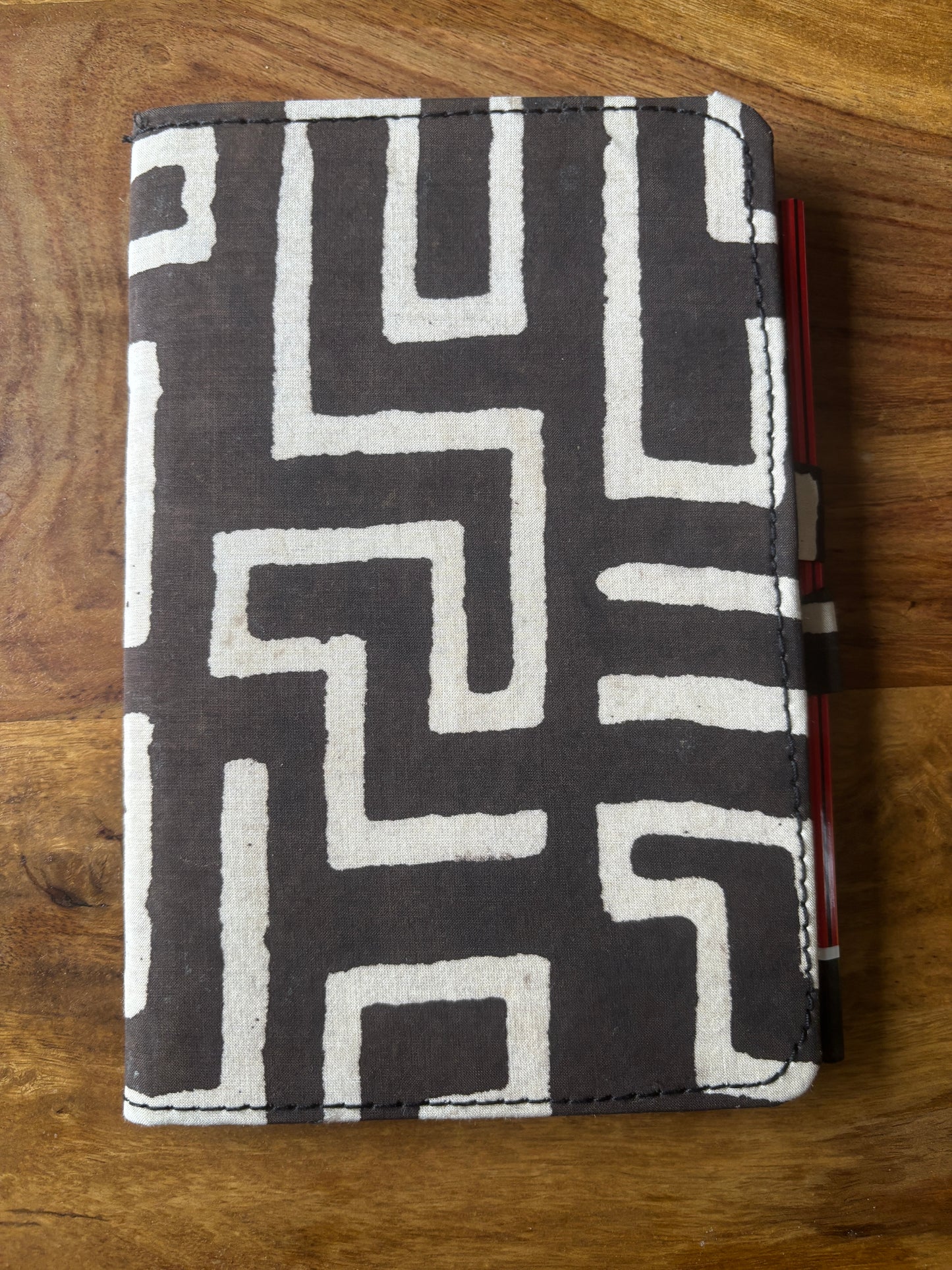 Fabric Diary with geometric pattern on a wooden surface