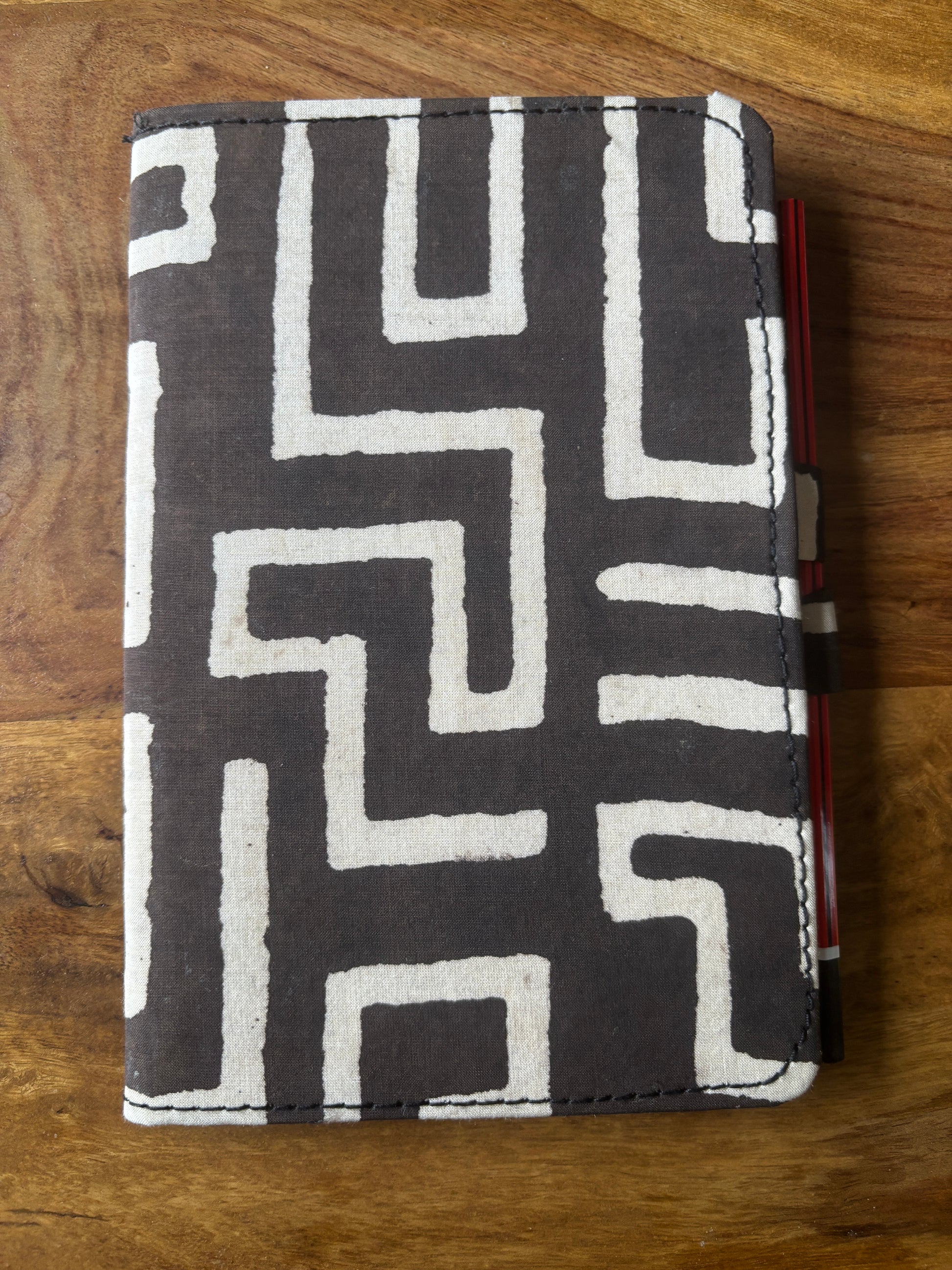 Fabric Diary with geometric pattern on a wooden surface