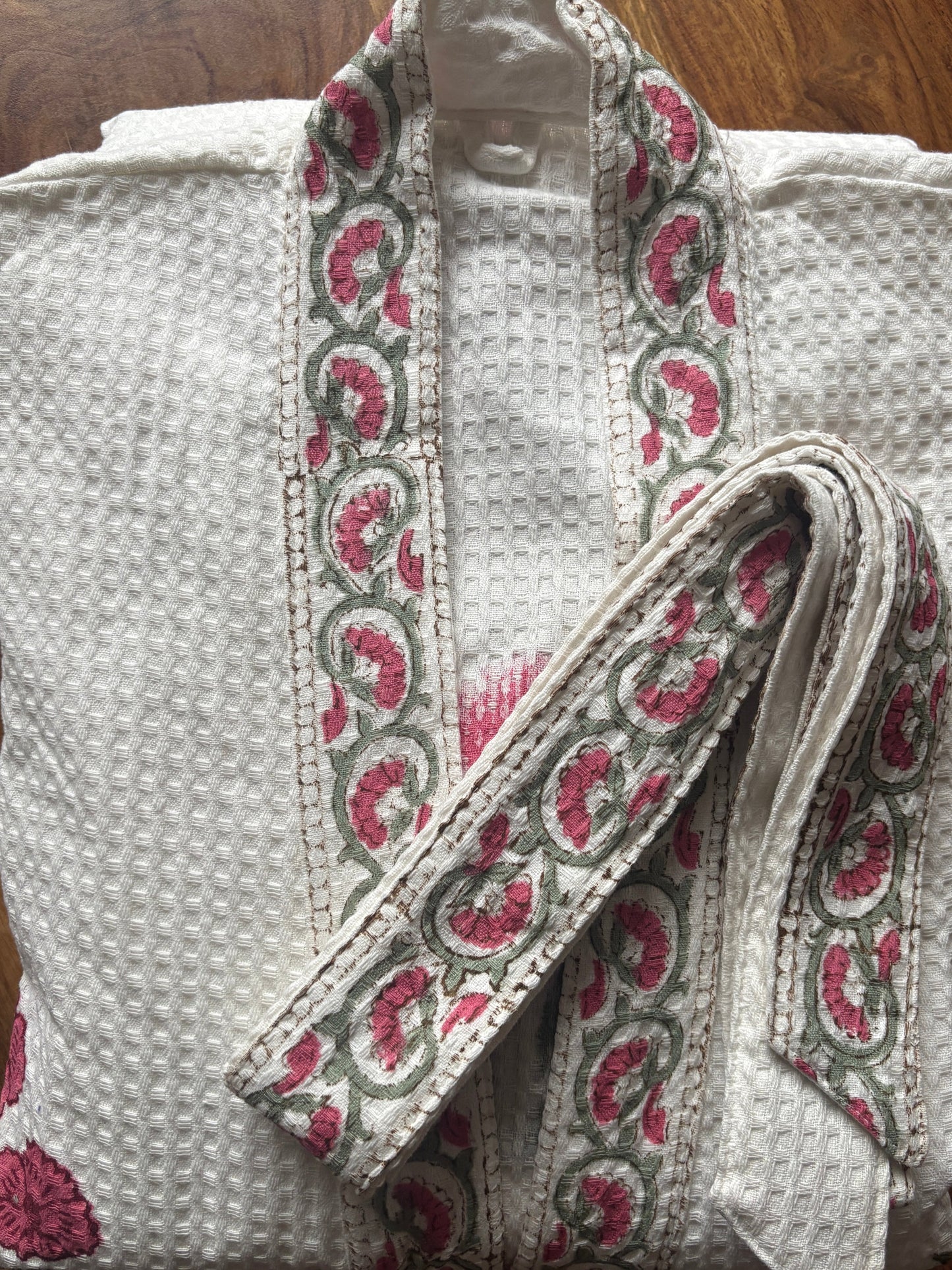 Blush pink floral waffle bathrobe hanging in bathroom, one size, 127 cm