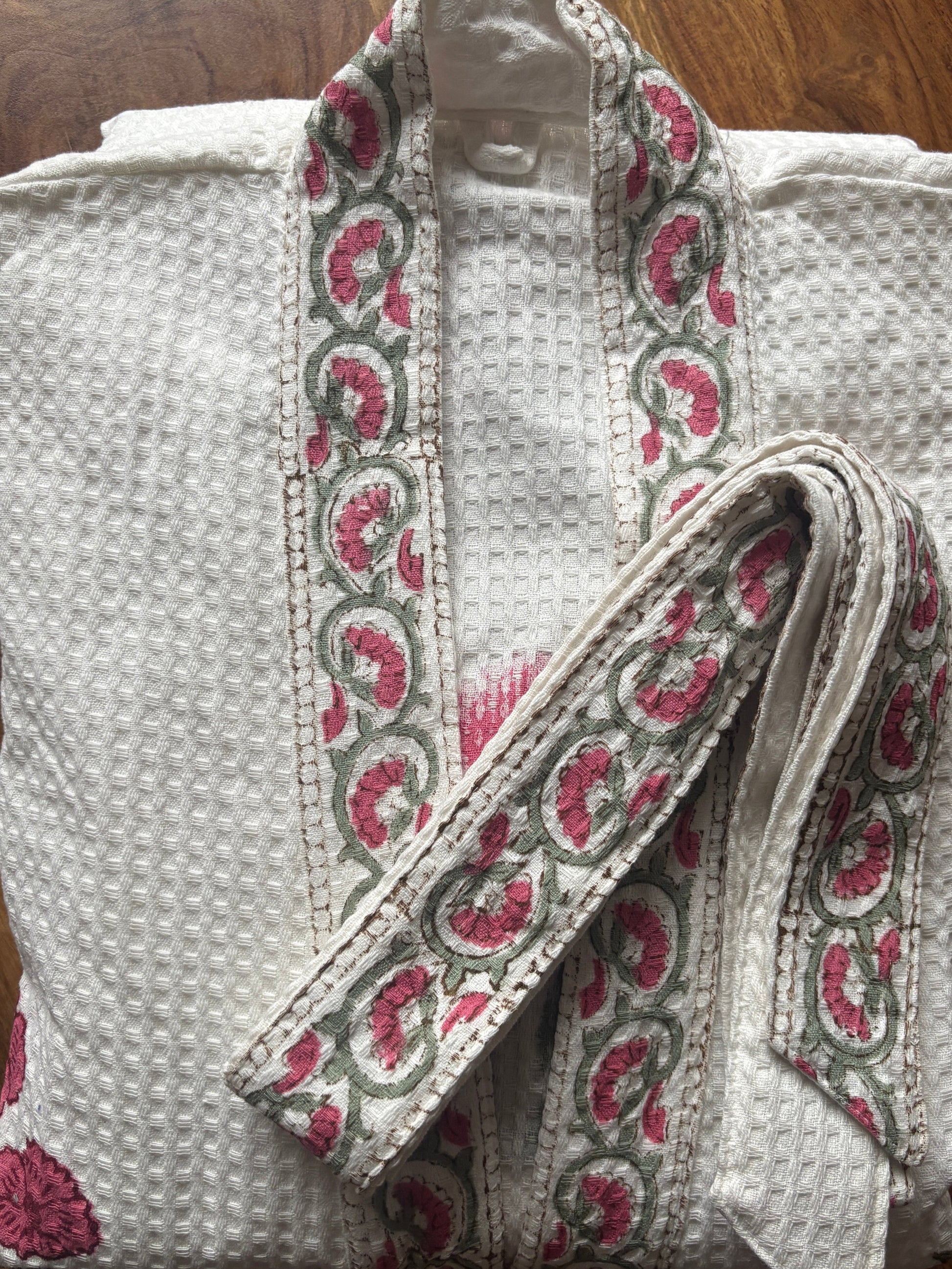 Blush pink floral waffle bathrobe hanging in bathroom, one size, 127 cm