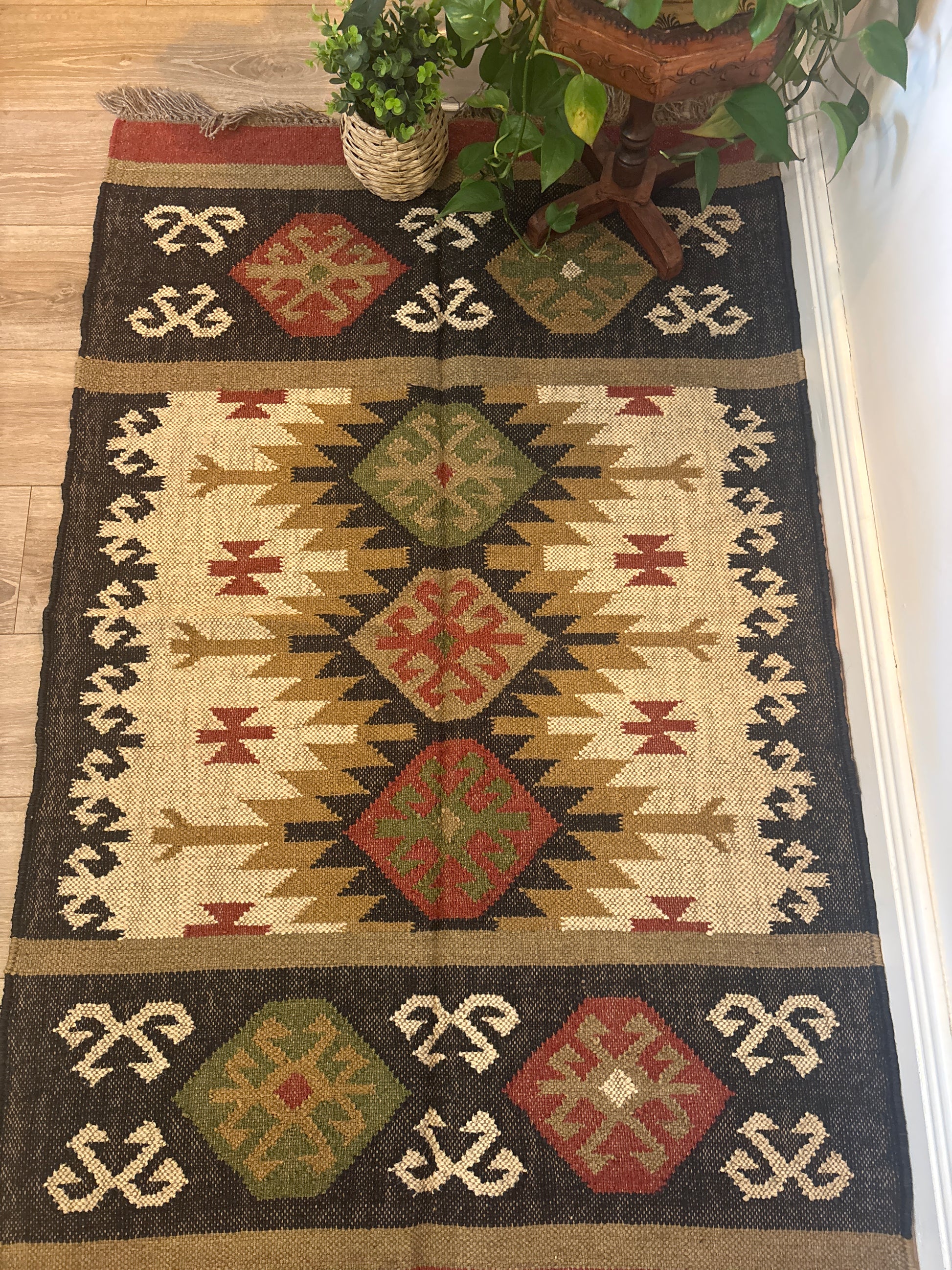 Decorative rug with geometric pattern on a wooden floor