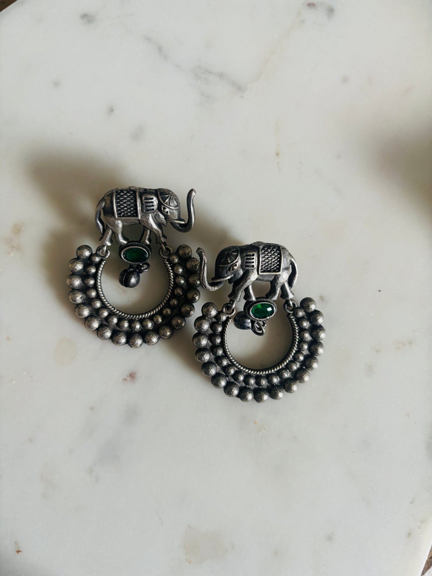 handcrafted oxidized metal drop earrings with elephant motif and subtle green stone accent, lightweight and stylish ethnic accessory.