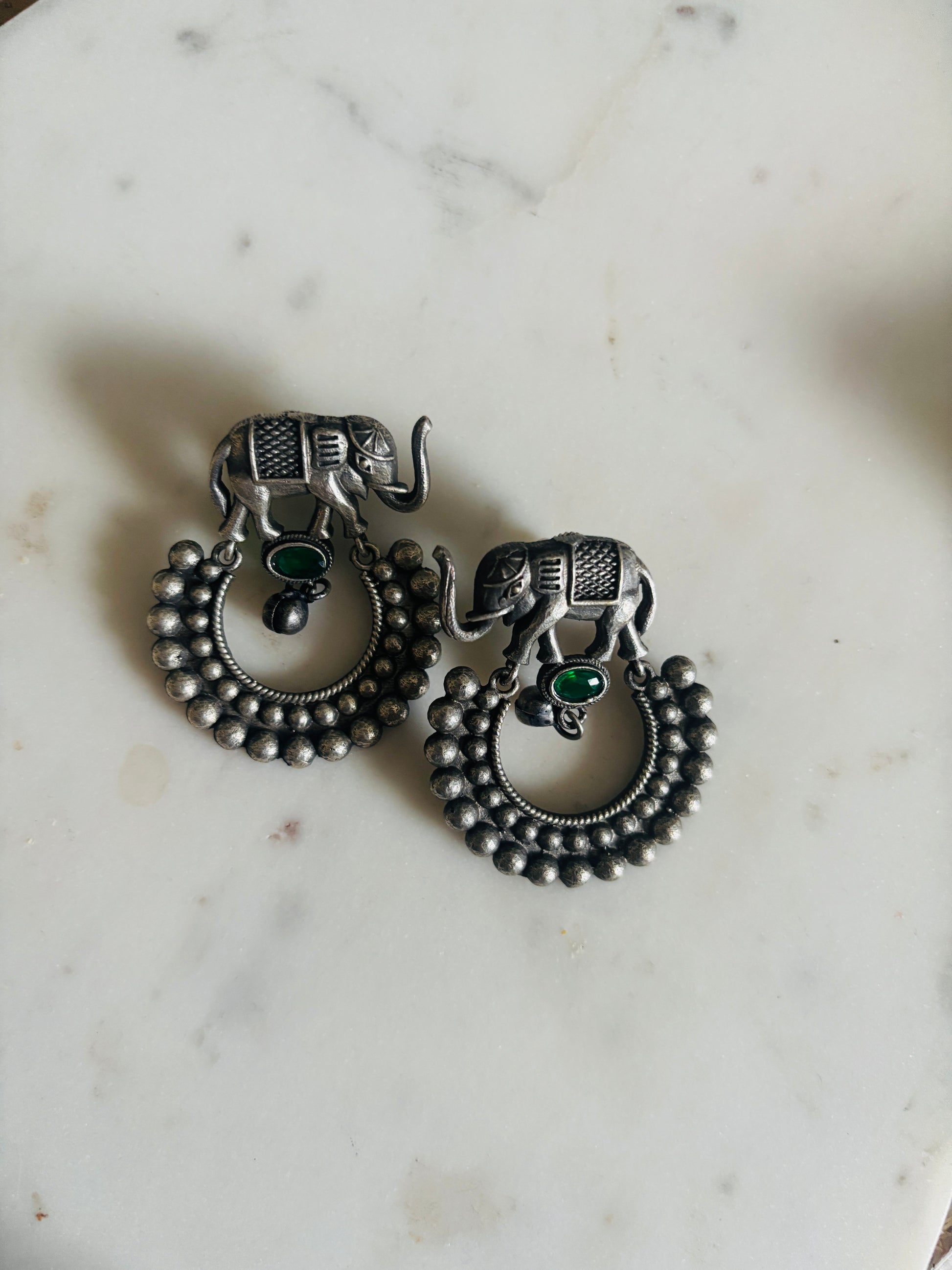 handcrafted oxidized metal drop earrings with elephant motif and subtle green stone accent, lightweight and stylish ethnic accessory.