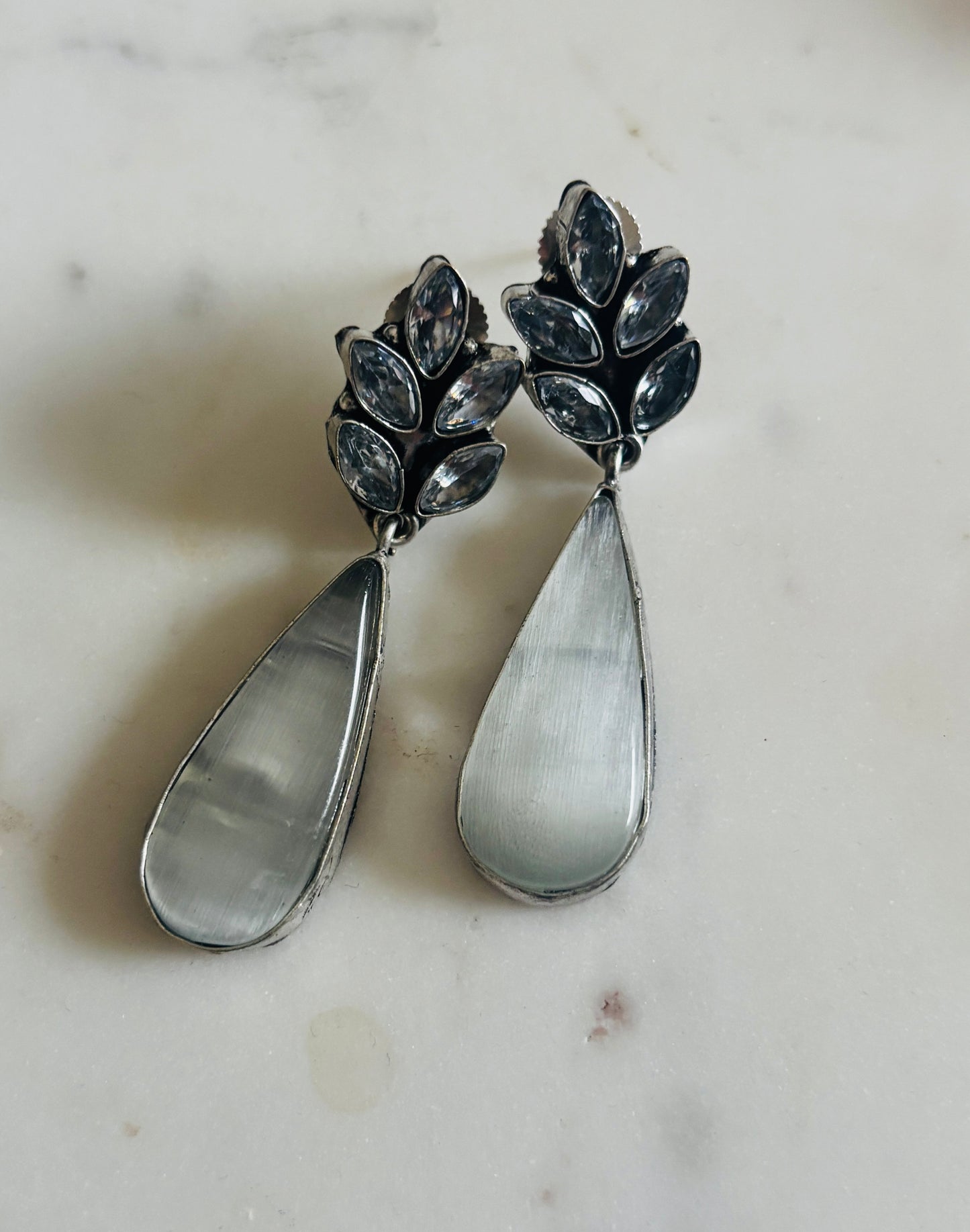 Ebony leaf teardrop earrings with black glossy pendant and sparkling crystal leaf‑inspired design, handcrafted fashion jewellery.