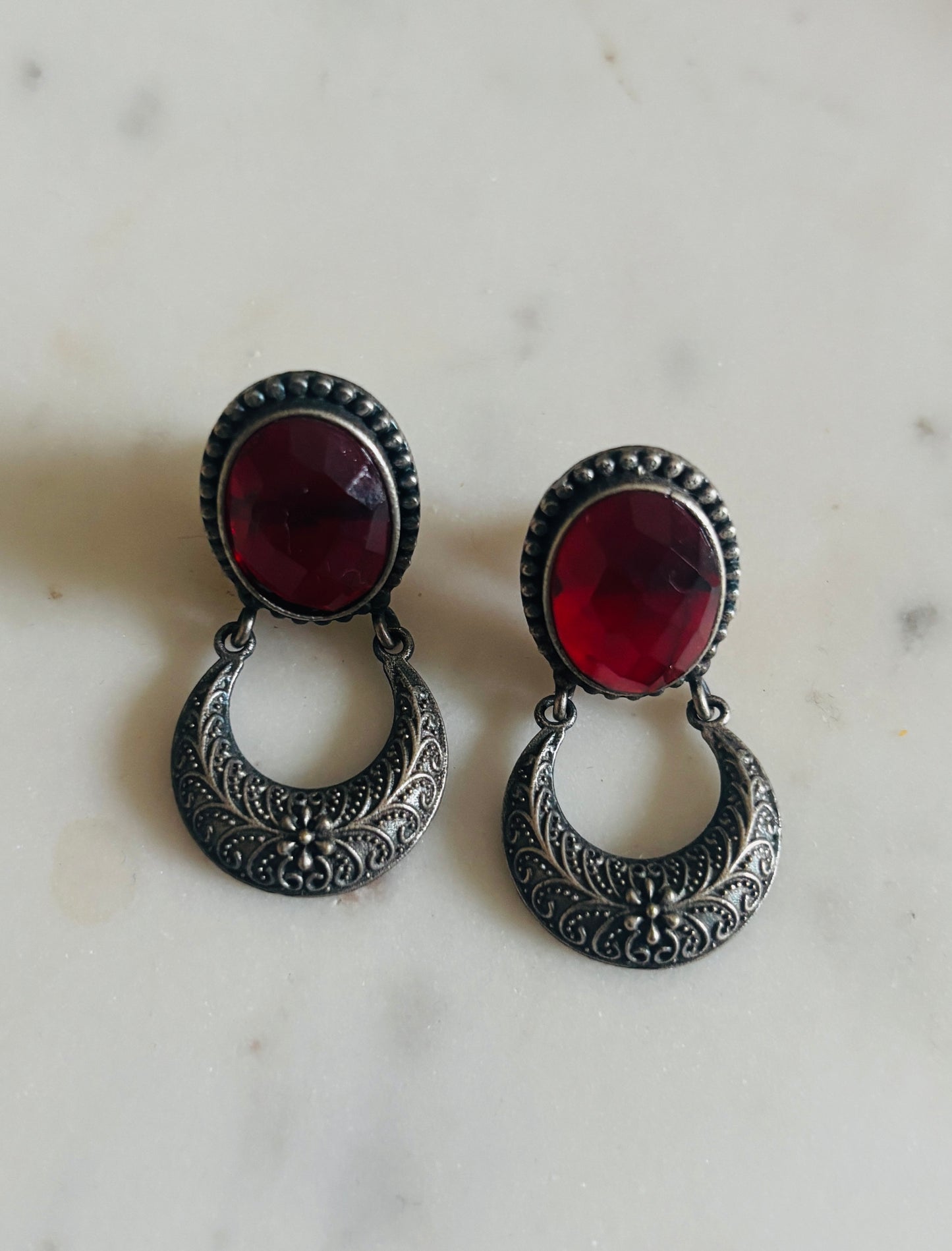 Handcrafted crescent oxidised drop earrings featuring a crimson red stone with antique-style detailing, ethnic fashion jewellery.