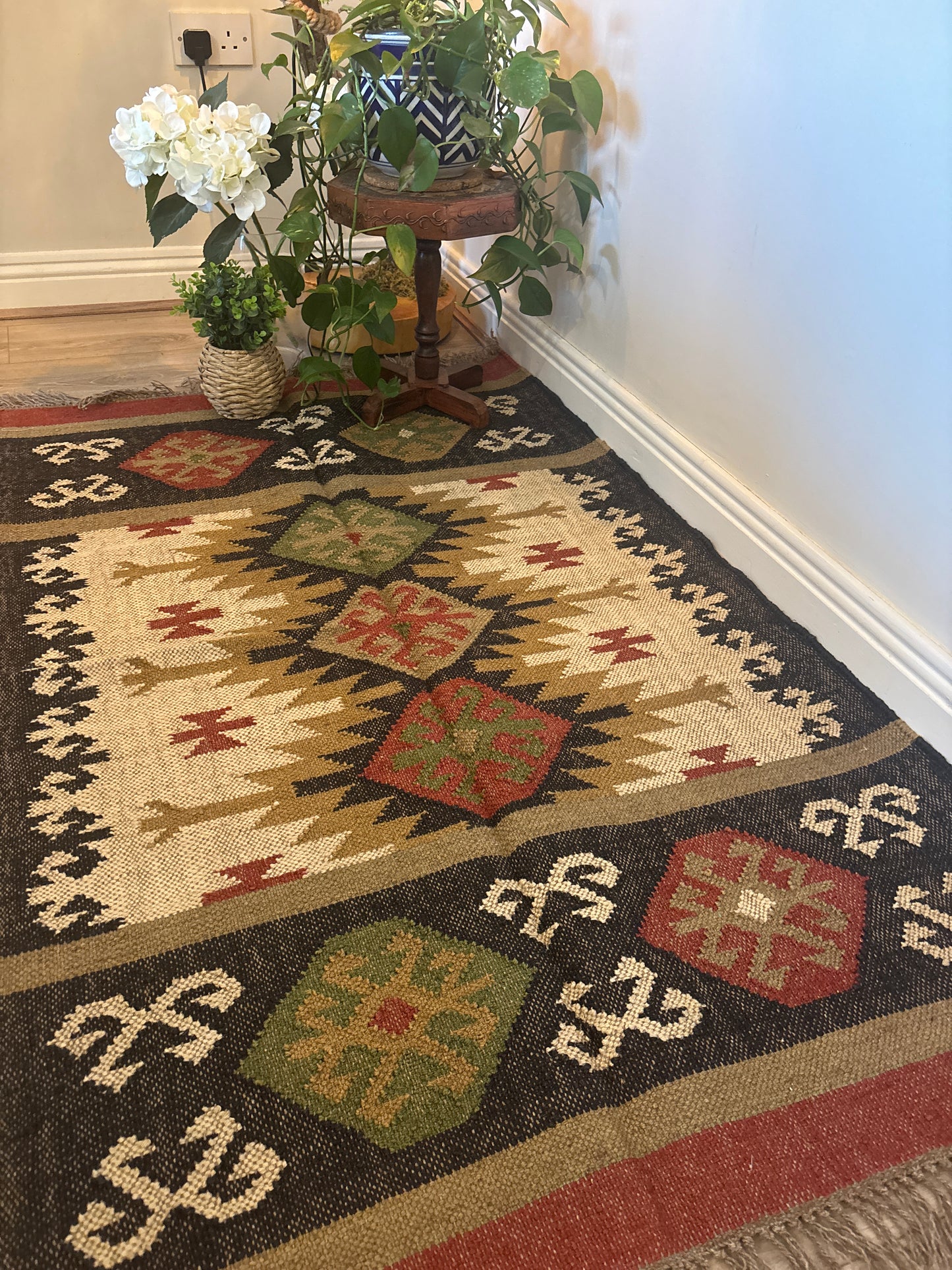 Decorative handwoven jute floor rug with geometric pattern in a room setting 