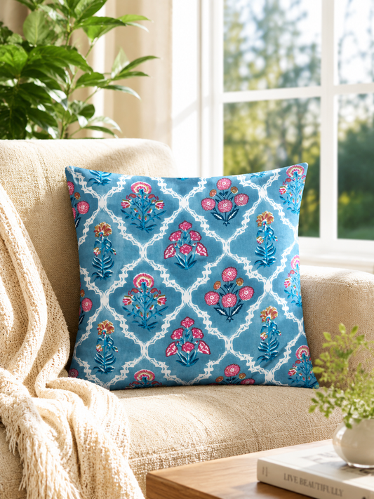 Decorative pillow with floral pattern on a beige couch in a bright room.