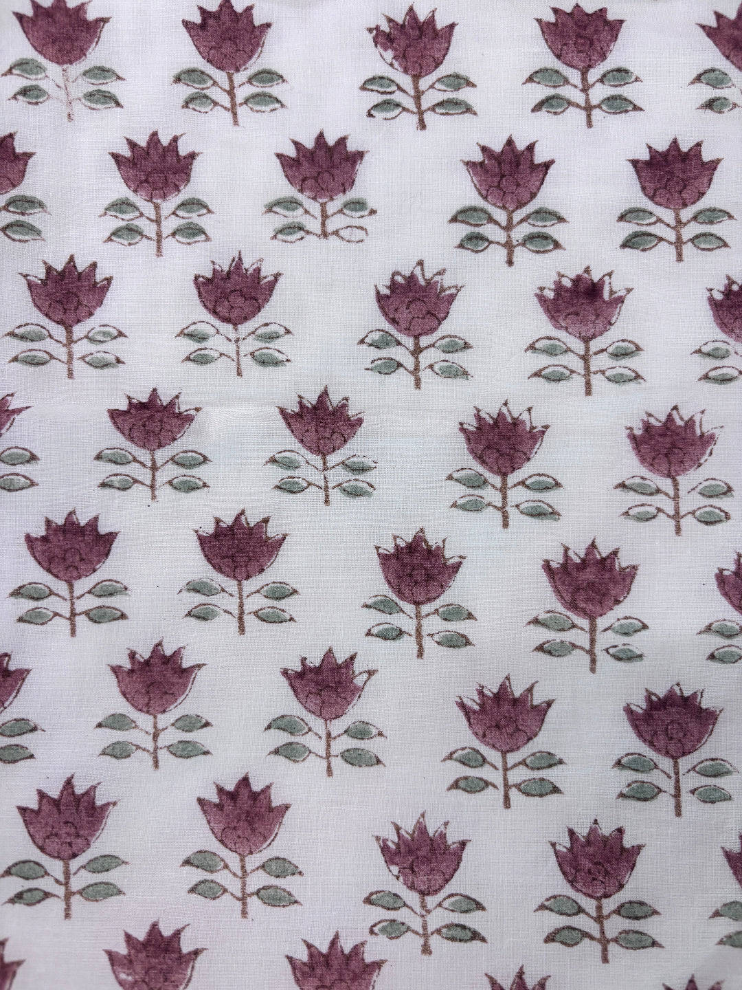 Patterned fabric with brown flowers and green leaves on a white background