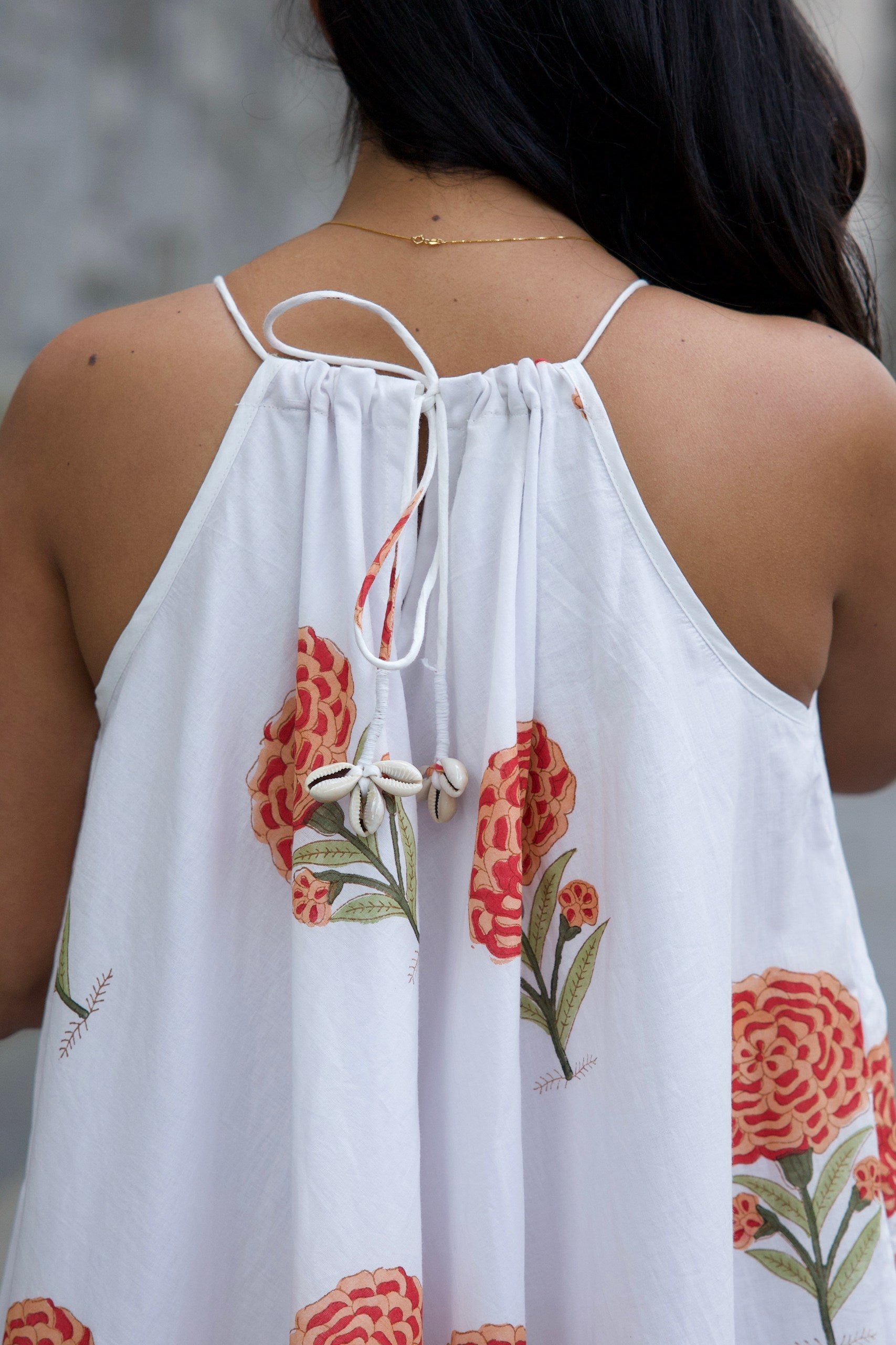 White dress with red floral patterns 