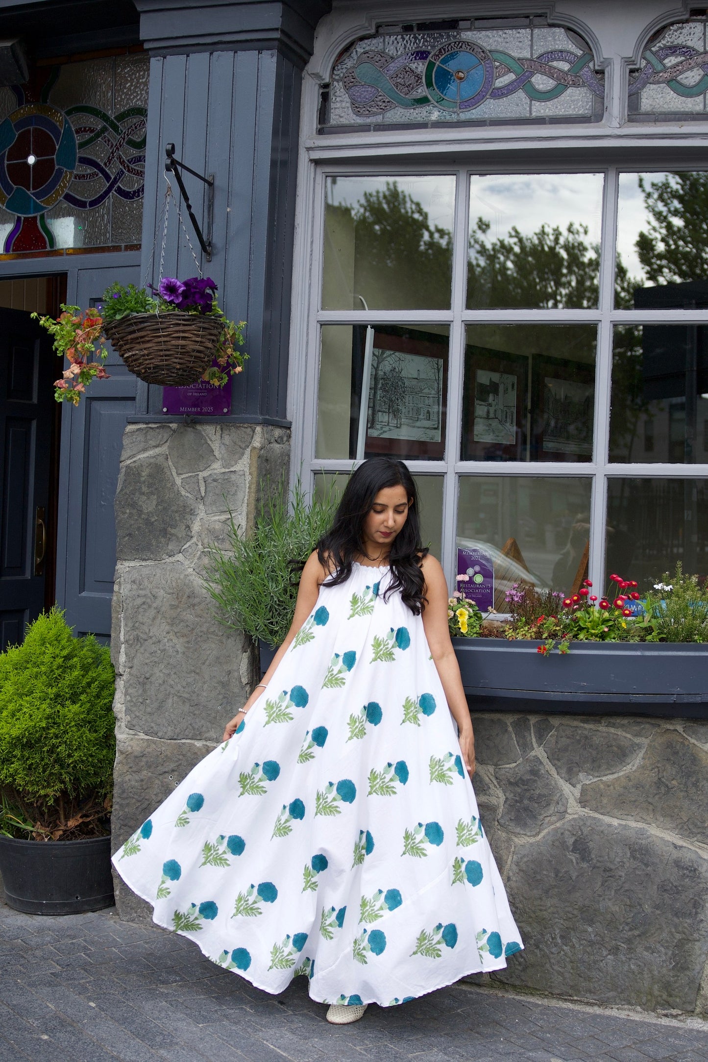 White cotton flare dress with dark blue floral block print and shell detailing