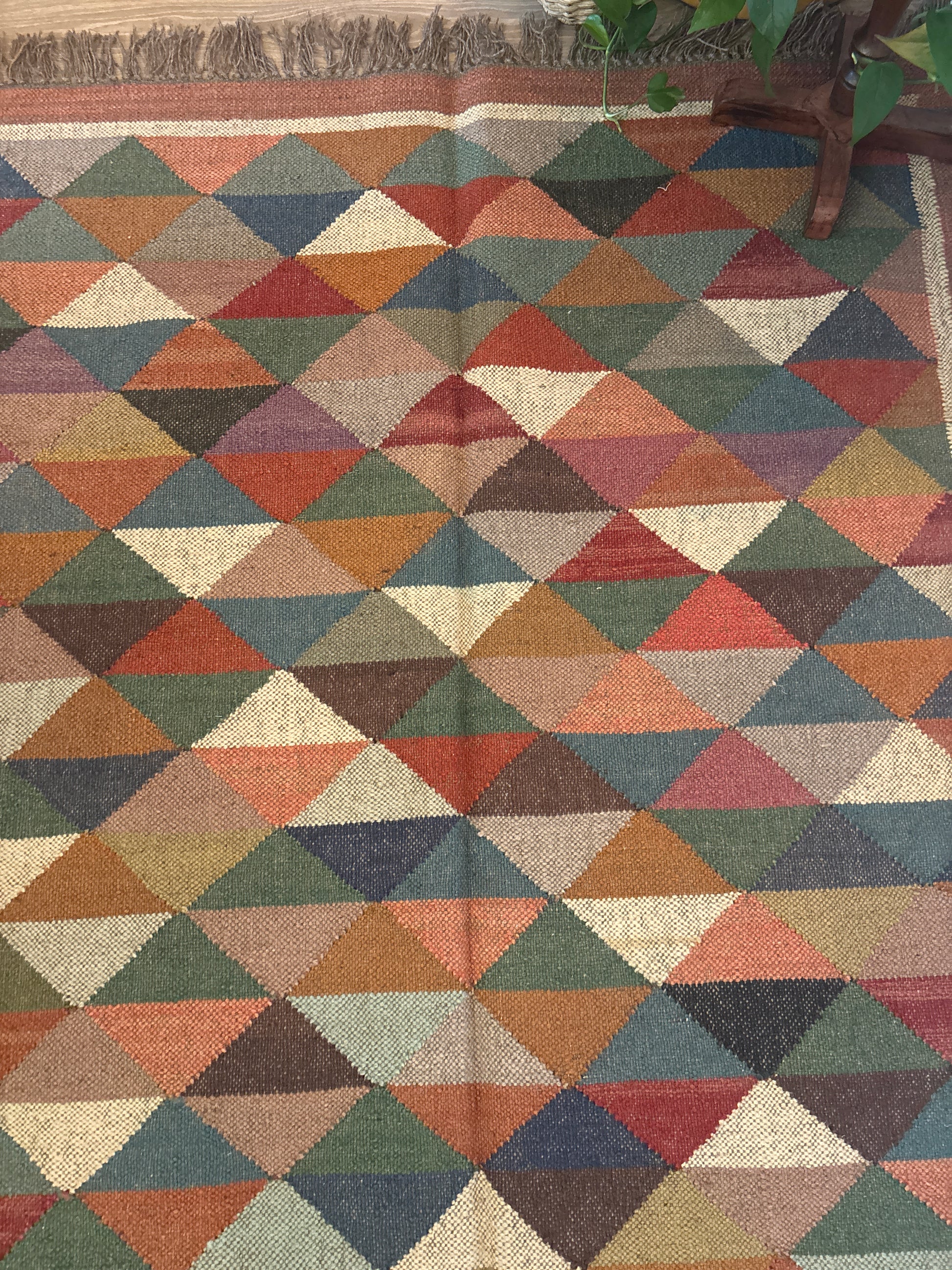 Multicolored geometric patterned rug with a textured surface.