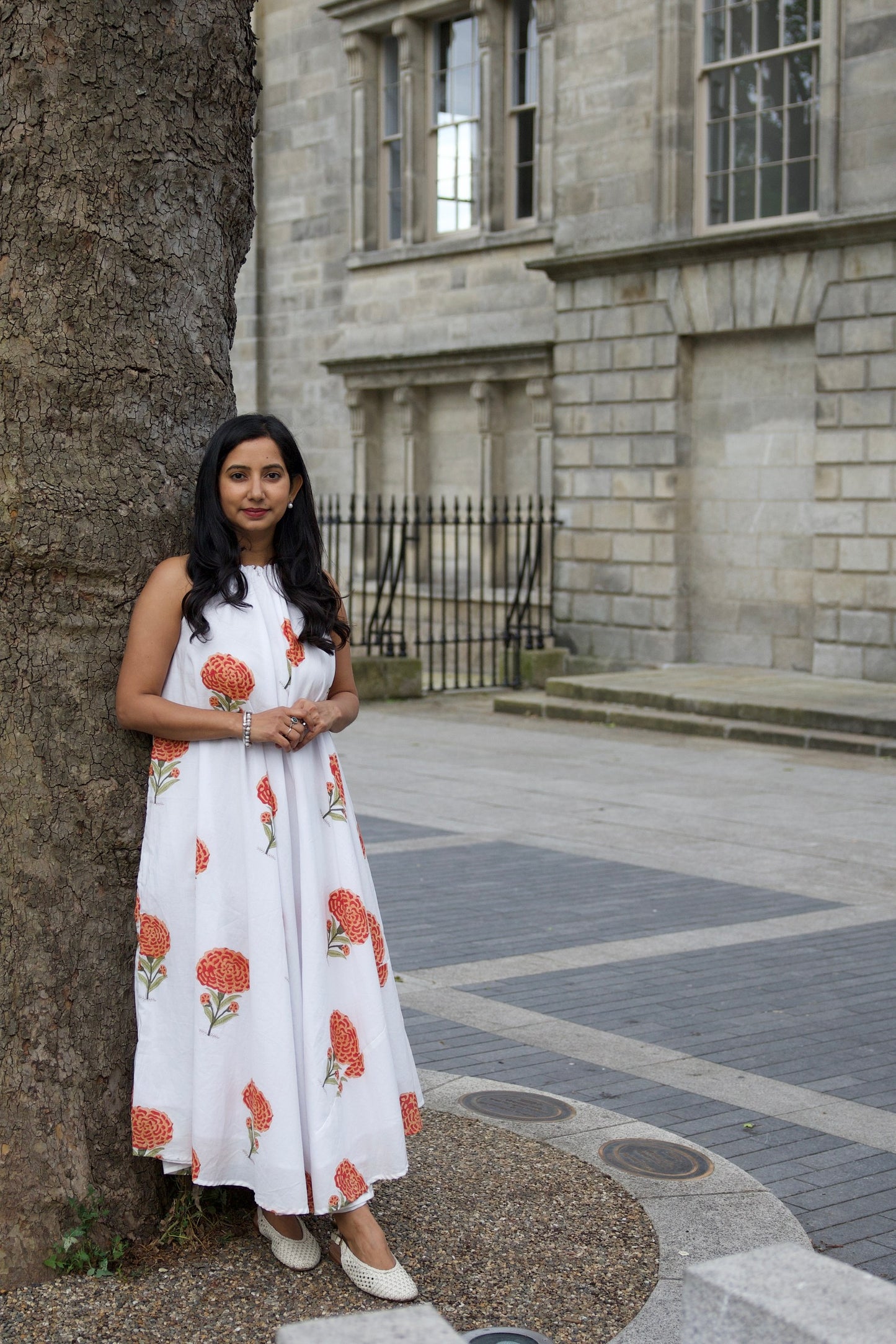 Woman in a white dress with floral patterns in dublin ireland
