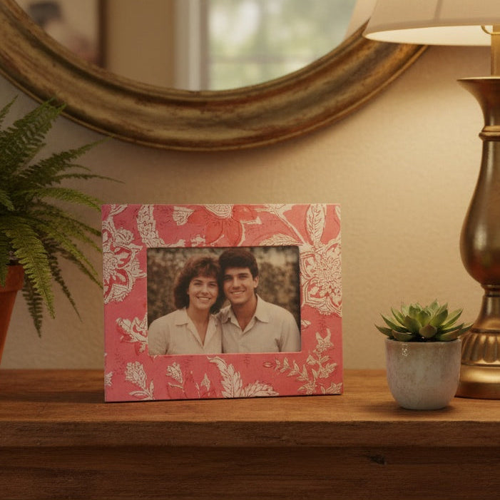 Handmade pink floral picture frame holding a 3×5 photograph, artisanal block‑printed fabric frame for home décor.